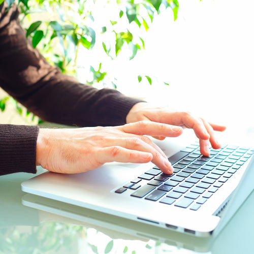 Someone typing on a computer to represent leaving a review for Bundled. Discover sustainable, affordable, gently-loved children's clothing bundles at Bundled, supporting parents and the environment with curated, high-quality options for newborns to toddlers at affordable and cheap price points.