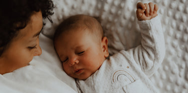 Mom with her newborn baby that is wearing a cute and cosy sleeper. Discover sustainable, affordable, gently-loved children's clothing bundles at Bundled, supporting parents and the environment with curated, high-quality options for newborns to toddlers at affordable and cheap price points.